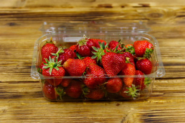 istock Fresh strawberry in plastic box on a wooden table 1249953267