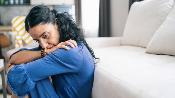 Mid adult woman in isolation at home during COVID-19 Mid adult woman in isolation at home during COVID-19 terrified stock pictures, royalty-free photos & images