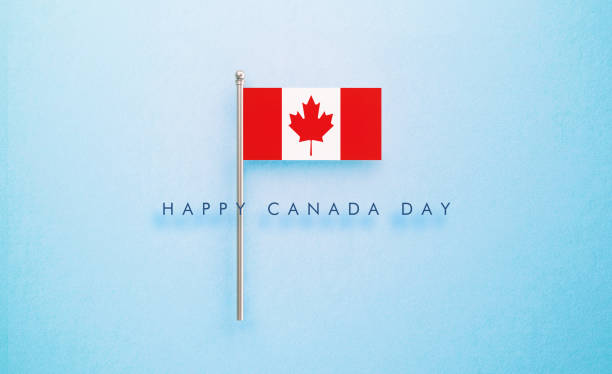 Happy Canada Day message next to tiny Canadian flag on blue  background. Horizontal composition with copy space. Front view.