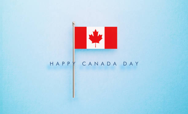 Happy Canada Day message next to tiny Canadian flag on blue background. Horizontal composition with copy space. Front view.
