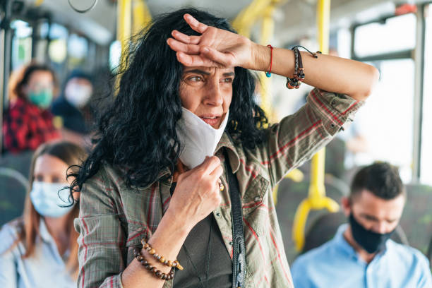 istock Woman gets a panic attack on the bus while wearing a protective mask during COVID-19 1249955463