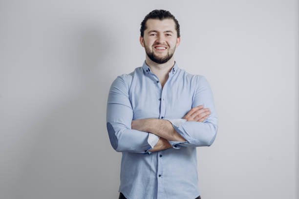 istock Successful handsome businessman with a beard points. Arms crossed and smile 1249955667