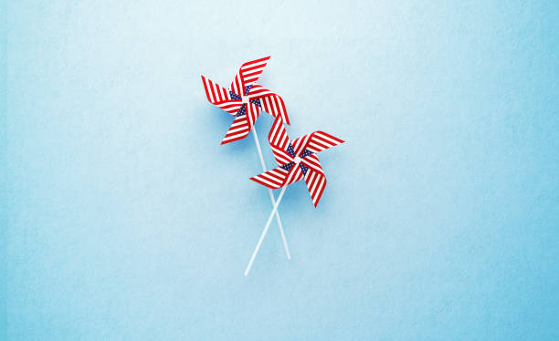 istock Paper Pinwheel Pair Textured with American Flag on Blue Background 1249955719