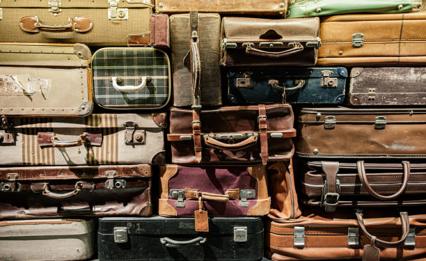 istock Stack of old assorted vintage styles leather and fabric luggages 1249956602