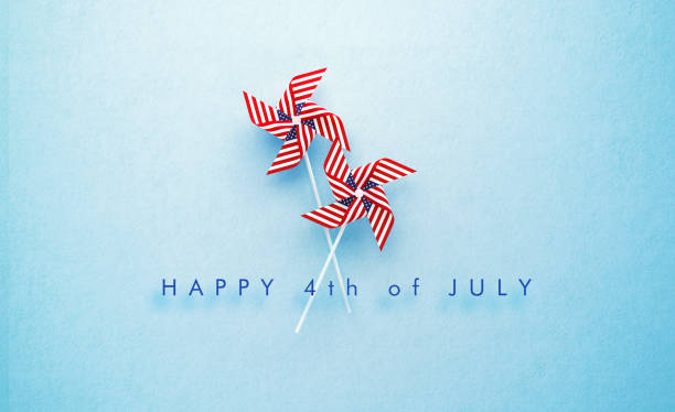 Happy 4th of July Message and Paper Pinwheel Pair Textured with American Flag on Blue Background Happy 4th of July message and paper pinwheel pair textured with American flag on blue background. Horizontal composition with copy space. Front view. 4th of July concept. independence day holiday photos stock pictures, royalty-free photos & images