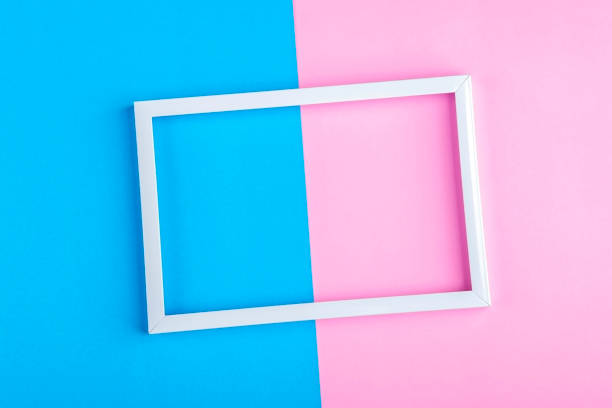 istock Empty white frame on a duotone background (blue, pink) with copy space for text or lettering. Minimal geometric lines composition. Top view, flat lay, mock up. 1249957712