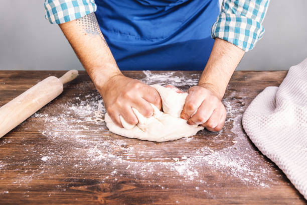 istock hands of a man kneading homemade bread dough 1249959746