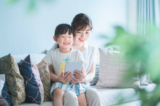 istock Mom and daughter operating a tablet device 1249959799