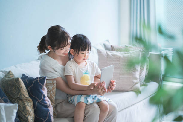 istock Mom and daughter operating a tablet device 1249959842