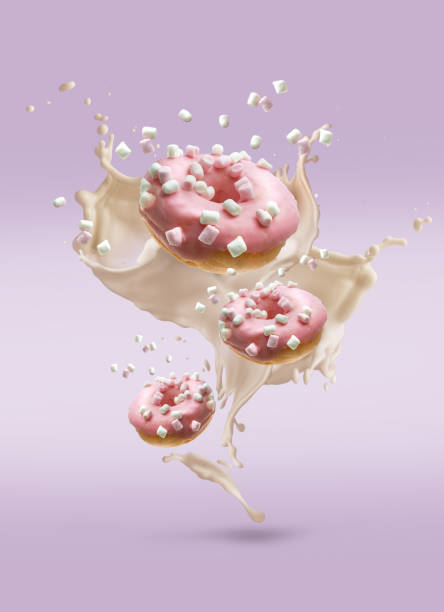 istock Creative composition of flying donuts with cream splashes and marshmallow 1249960008
