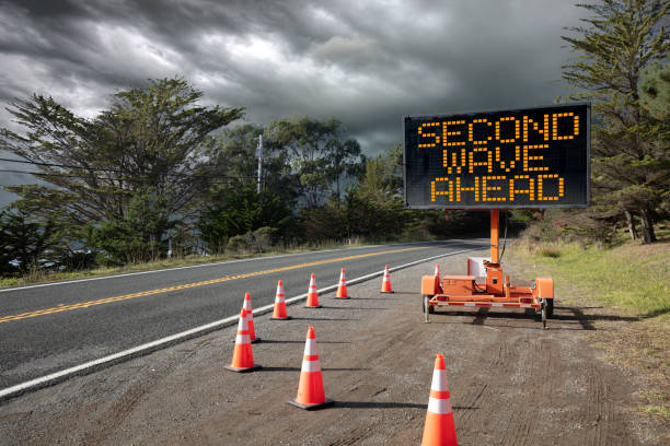 istock Second Wave of infections for Covid-19 VIRUS on traffic warning sign 1249960128