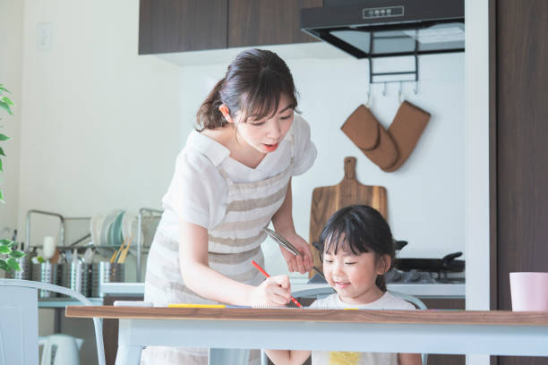 istock A girl drawing in the kitchen 1249960147