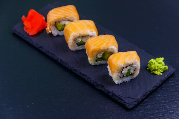istock Sushi rolls Philadelphia on a black slate 1249961132