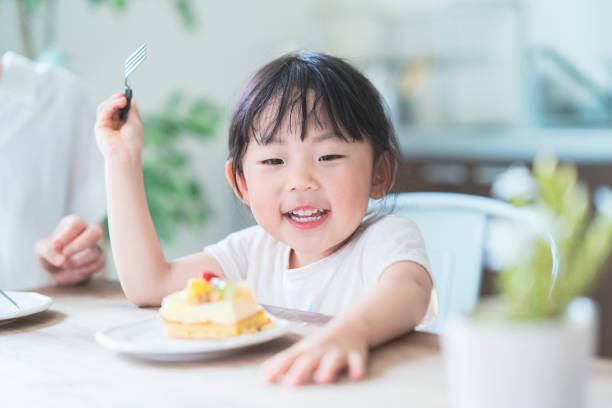 istock eating cake at dining table at home 1249961155
