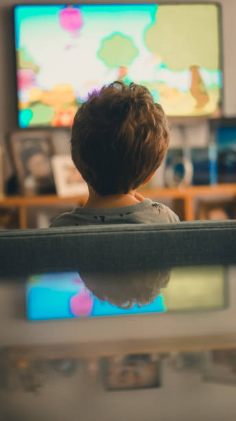 istock Child watching TV in the house 1249961468