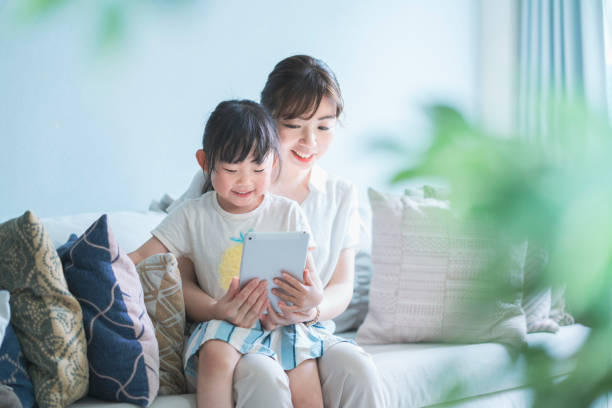istock Mom and daughter operating a tablet device 1249962077