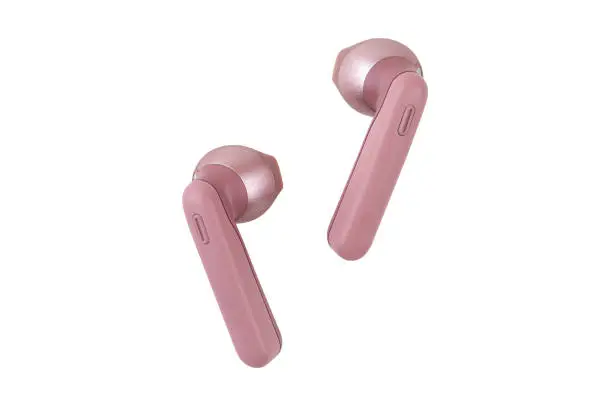 Photo of Wireless headphones on a white background. Pink wireless headset close-up.