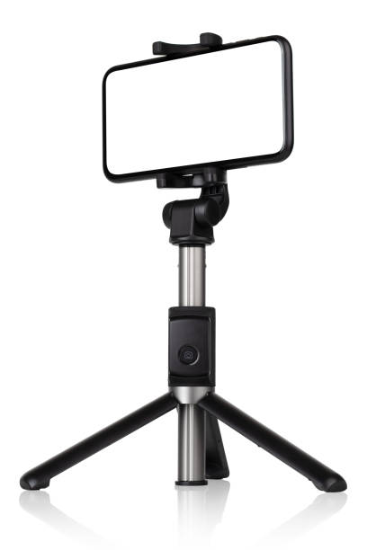 istock Smartphone with a white cut-out screen on a monopod. Selfie stick and smartphone on a white background. 1249962422