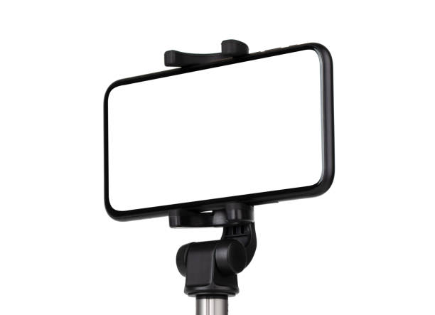 istock Smartphone with a white cut-out screen on a monopod. Selfie stick and smartphone on a white background. 1249962447