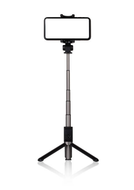 istock Smartphone with a white cut-out screen on a monopod. Selfie stick and smartphone on a white background. 1249962463
