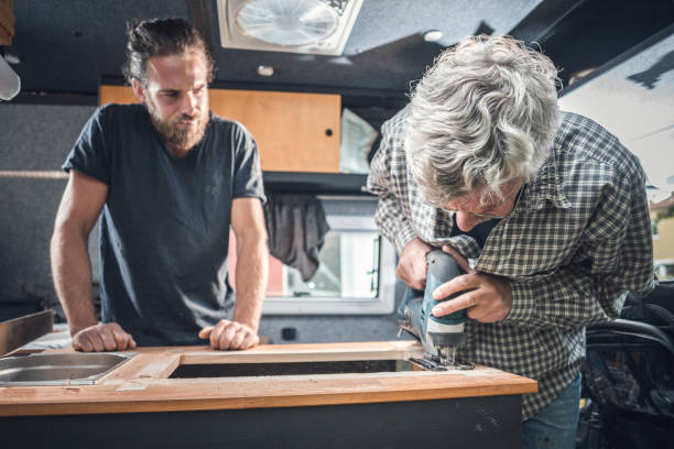 istock Father and adult son working on a camper van conversion 1249965092