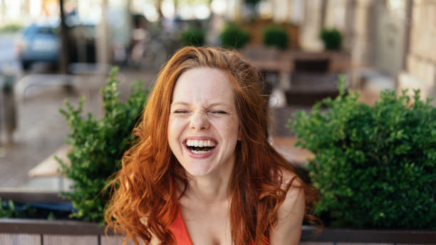 istock Cute vivacious young woman having a good laugh 1249965160