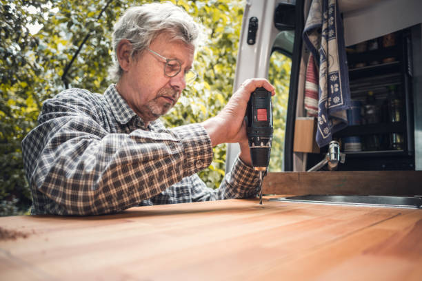 istock Senior man working on his caravan with a power drill 1249965177
