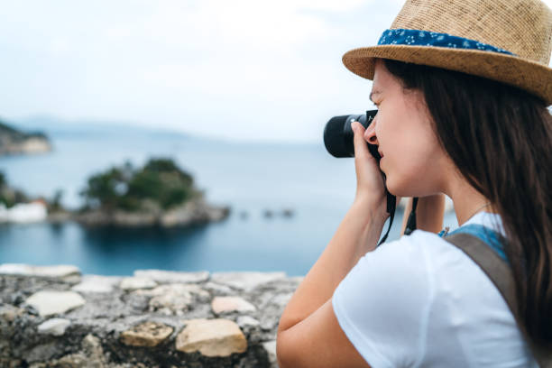 istock Woman making photos at seaside viewpoint 1249965795