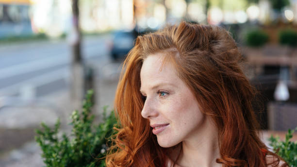 istock Attractive redhead woman with a faraway expression 1249966408