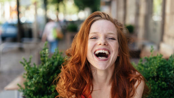 istock Young woman laughing at the camera 1249966784