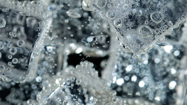 istock ice cube in fizzy splashing water with soda bubble 1249967675