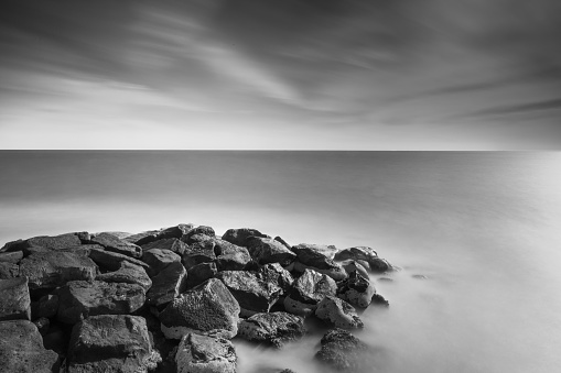 Super long exposure of rocks in the sea with waves forming a dreamy effect.