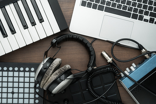 top view of home music studio. music production equipment on the table. music making tools on wooden background. photo of music production gear for modern independent beatmaker