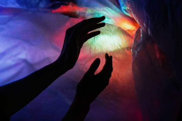 istock Silhouette of hands entering a colorful vortex 1249969568