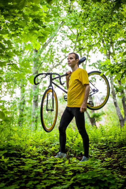 istock A young Man stopped to rest With his Bicycle in a public Park. 1249972977