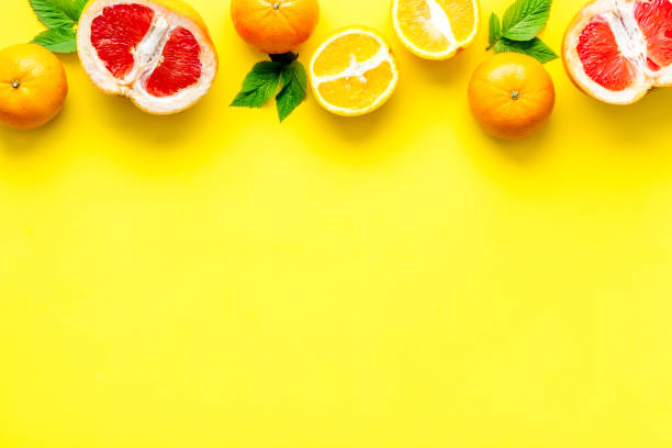 istock Citrus fruits on yellow background top view 1249973016