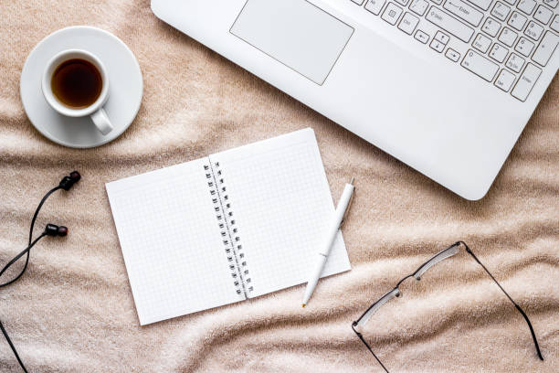 istock workplace at home - laptop on a bed, top view 1249973818