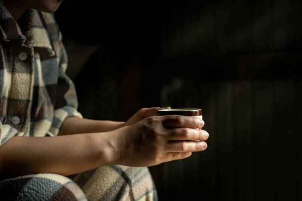 istock Close up,  people hand-holding hot coffee cup are drinking on the breakfast morning backdrop is black. 1249974171
