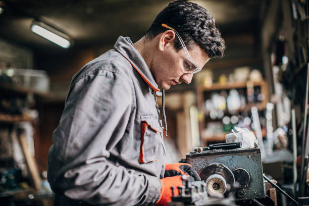 istock Young professional craftsman fixing plexiglass products in his workshop 1249976882
