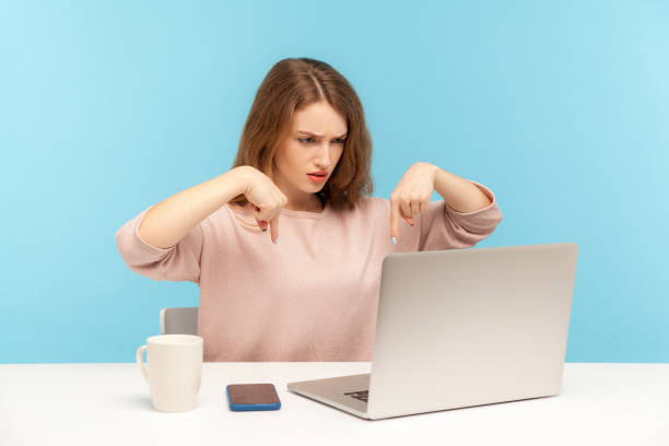 istock Here and right now! Strict angry lady boss pointing fingers down while talking on video call on laptop, controlling 1249977075