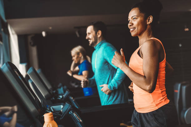 istock Young people running on a treadmill in modern gym 1249977813
