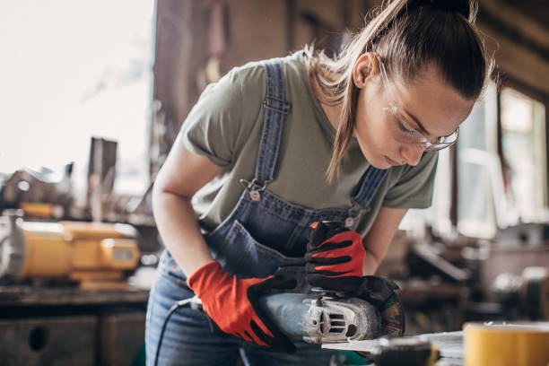 istock One young woman working with angle grinder in workshop 1249978334