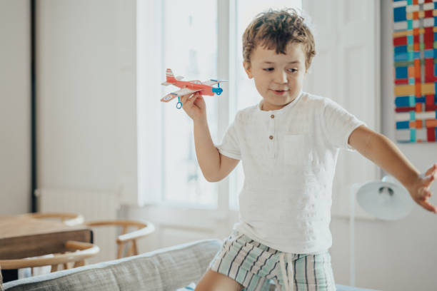 istock Boys playing with paper planes during lockdown for COVID-19 1249979230