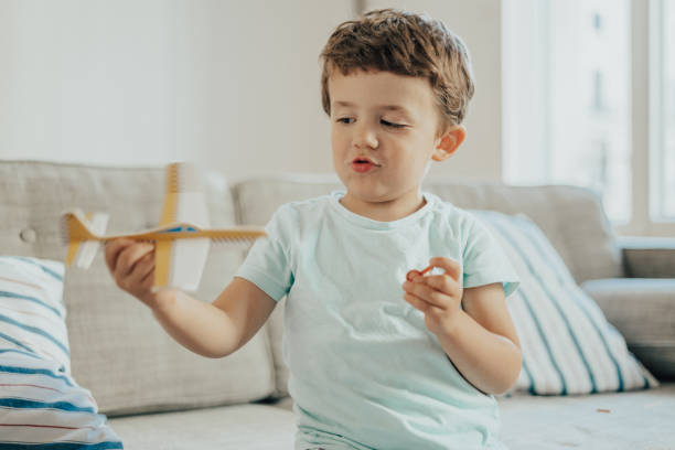istock Boys playing with paper planes during lockdown for COVID-19 1249979287