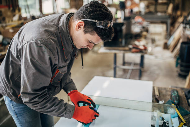 istock One manual worker marking a measurement on a piece of plexiglass 1249981246