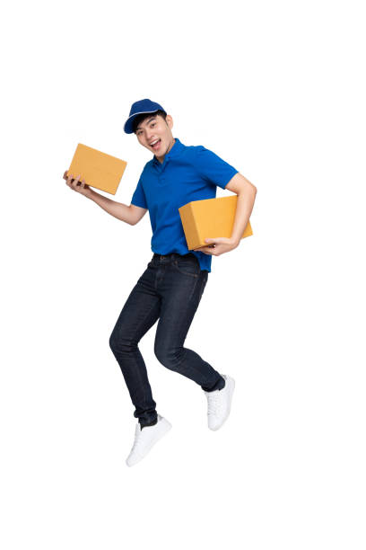 istock Young Asian delivery man jumping and holding parcel box isolated on white background 1249981623