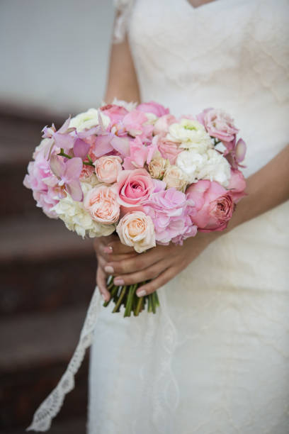istock Bride with beautiful wedding bouquet, closeup 1249984084