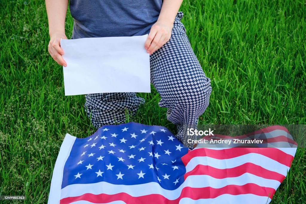 Protest after George Floyd death, protest, woman kneel, copy space. USA flag, kneeling Kneeling Stock Photo