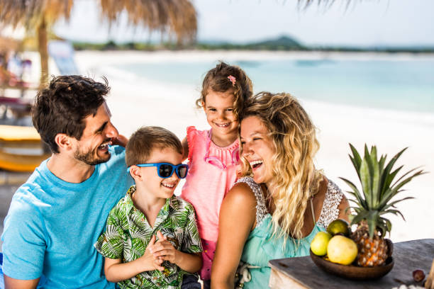 istock Happy parents having fun with their kids in a beach cafe. 1249985865