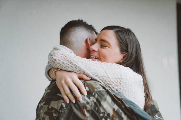 istock Wife hugging her husband in army uniform 1249985989